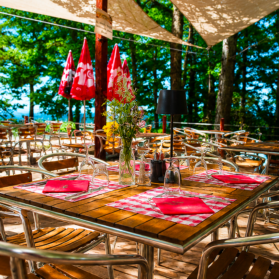 Terrasse du Petit Poucet avec nappe rouge et chalet en bois, Saint-Léon Allier